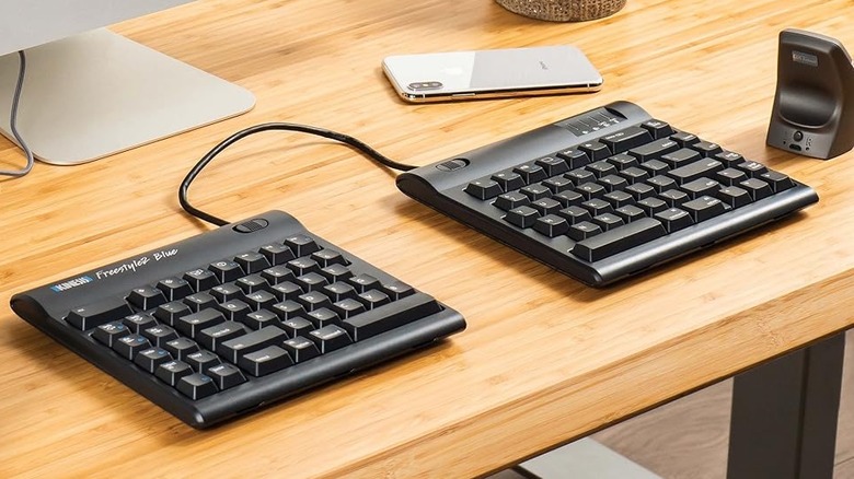The Kinesis Freestyle2 Ergonomic Keyboard on a wooden table.