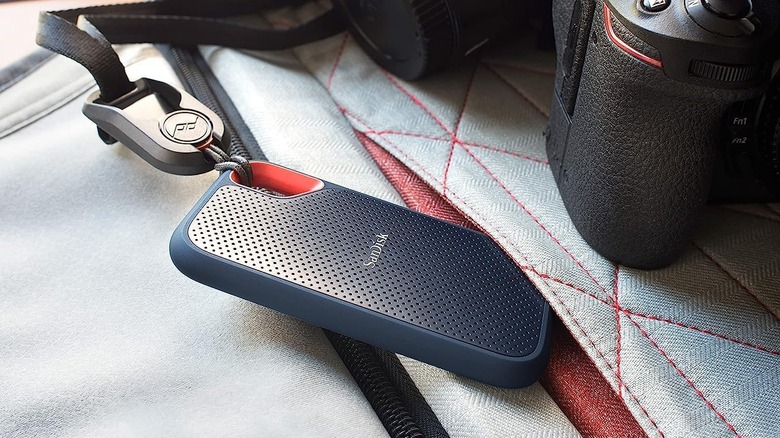 The SanDisk Extreme Portable SSD in a bag with a digital camera.