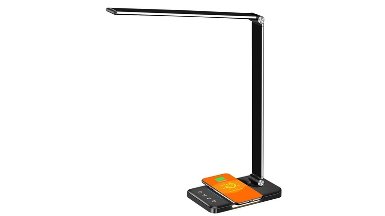 The Afrog EK009A LED desk lamp wirelessly charging a phone, on a white background.