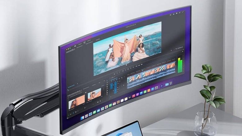A desk space with a curved monitor