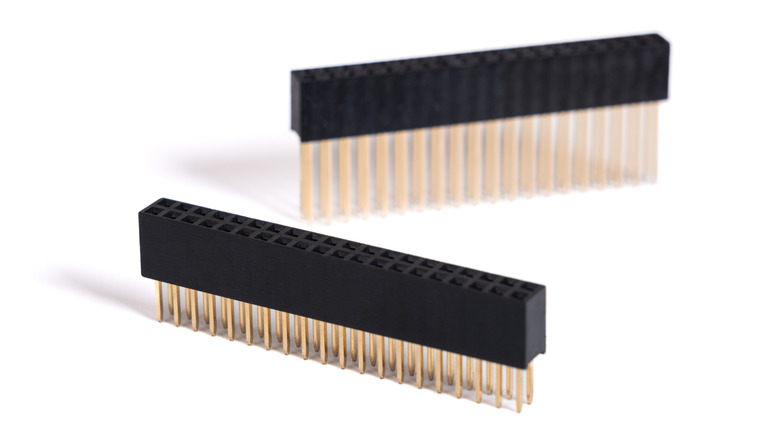 Two stacking headers with rows of holes and long pins