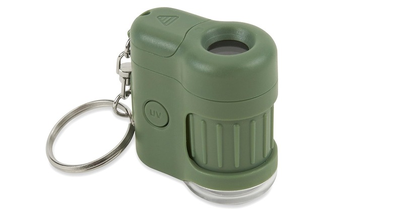 The Carson MicroMini pocket microscope with a keychain against a white background.