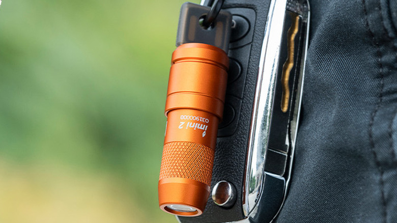 The OLIGHT imini 2 flashlight attached to a car key fob.