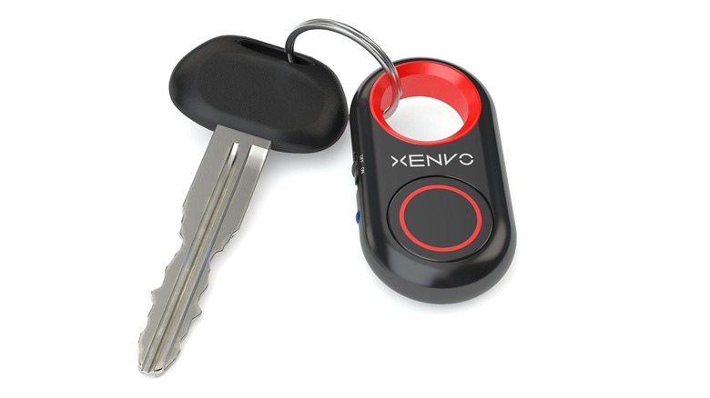 The Xenvo Shutterbug remote Bluetooth shutter attached to a keychain against a white background.