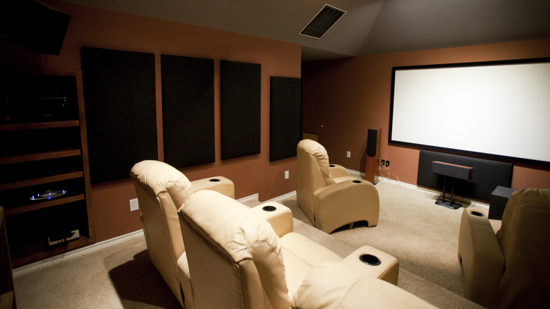A home theater setup with acoustic paneling on the wall and a nice, thick carpet for sound absorption