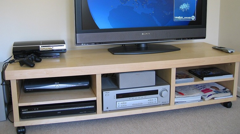 Home theater shelf with poor ventilation and the center audio channel covering the receiver vents