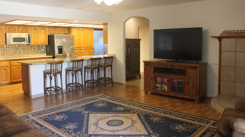 TV in a big room around ten feet away from the couch