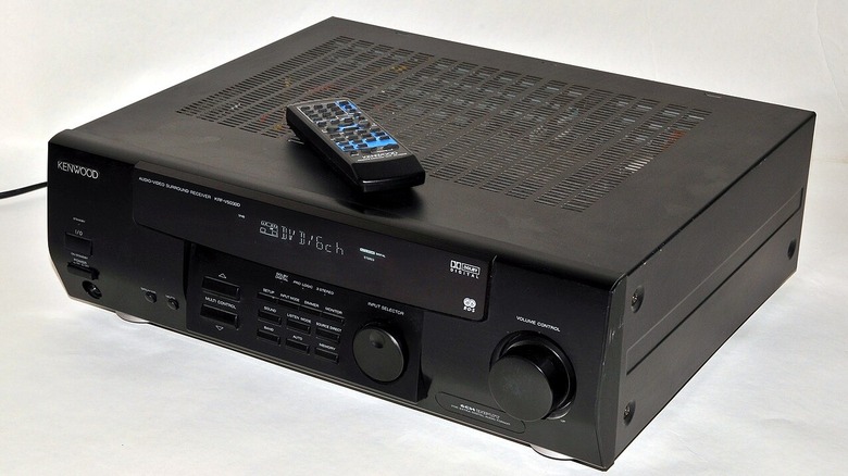 A Kenwood A/V Receiver with remote control placed on top.