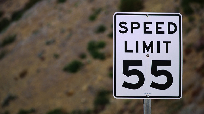 A sign saying speed limit 55