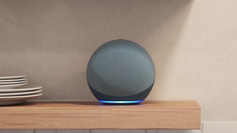 Amazon Echo on a counter top with blue light on the bottom, indicating its on