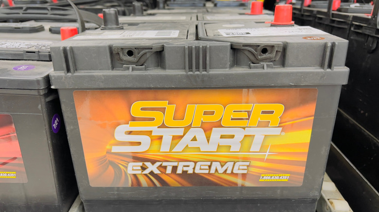 A Super Start Extreme car battery with other car batteries on display.
