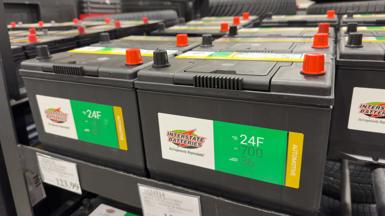 Interstate car batteries sitting on shelf in a store.