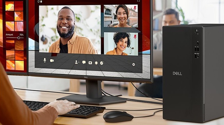 Video calling on a monitor screen connected to a Dell PC, keyboard, and mouse.