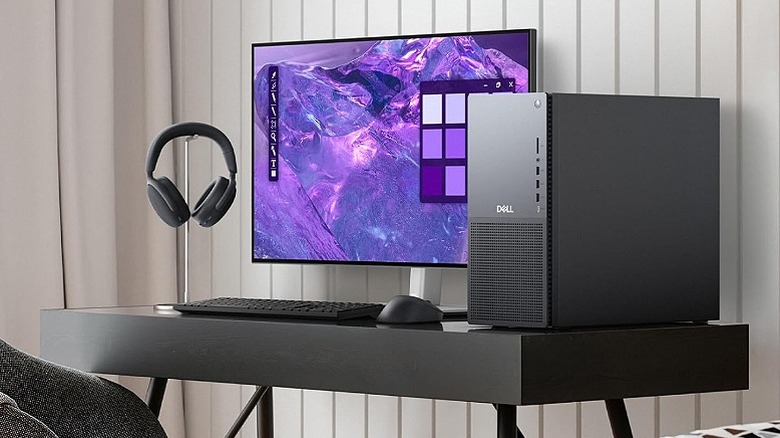 Purple wallpaper on a monitor with a Dell PC setup.