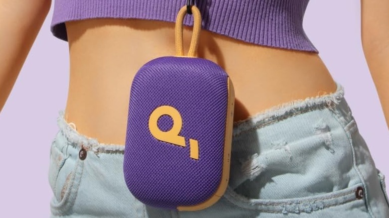 The Soundcore Select 4 Go portable speaker hangs from a loop around a woman's waist.