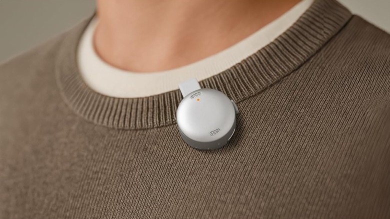 Soundcore Work AI voice recorder being work on the neck of a brown jumper using the magnetic clip