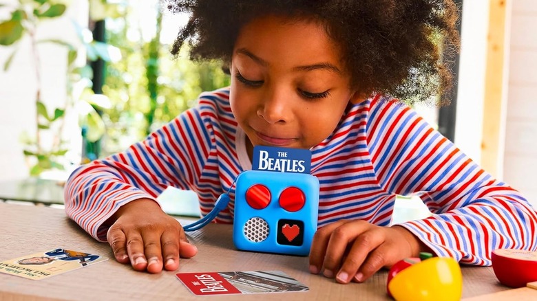 A child listening to The Beatles on the Yoto Mini audio player.