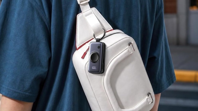 The INIU P81 SnapGo power bank clipped onto a bag.