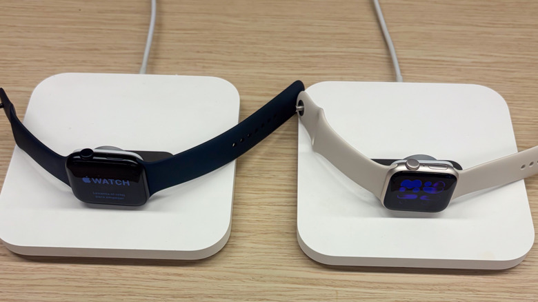 Two Apple Watches on charging stands.