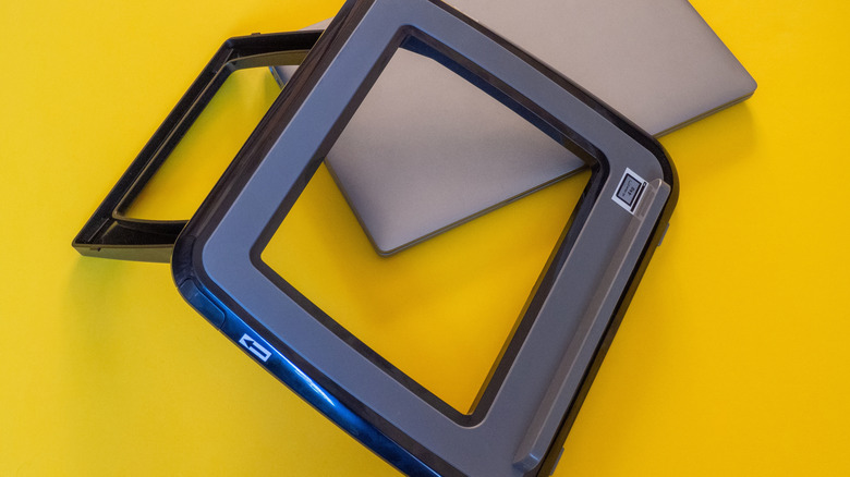 A plastic laptop stand on a yellow surface.