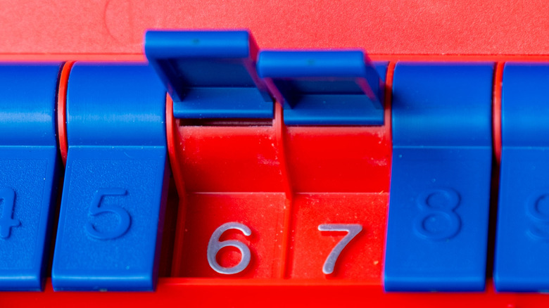 A red plastic counter with blue shutters open on numbers 6 and 7.