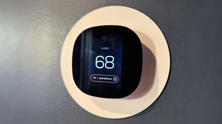 smart thermostat on a wall displaying the temperature