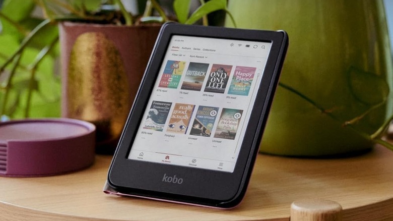 The Kobo Clara Color ebook reader on a wooden table.