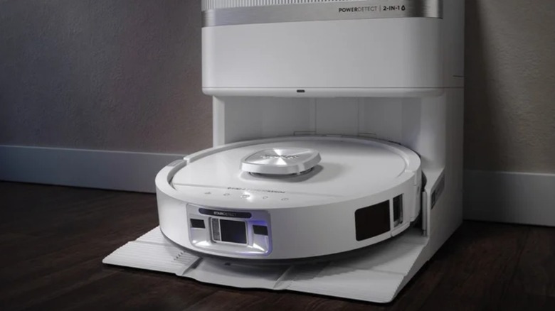 Shark PowerDetect robot vacuum with docking station sits up against a wall