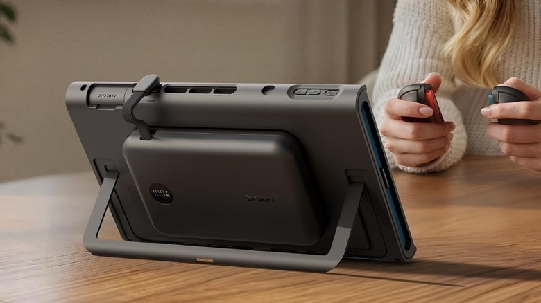 A person using Joy-Cons to play on the Switch 2, with the Belkin Charging Grip case installed.