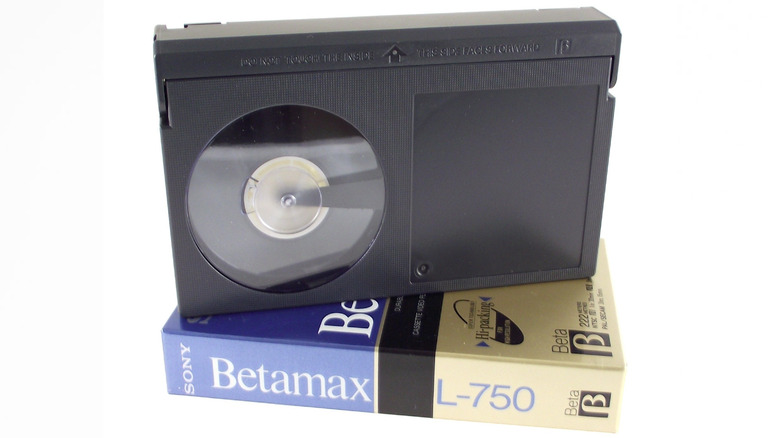 A black Sony Betamax tape resting atop its cardboard case.