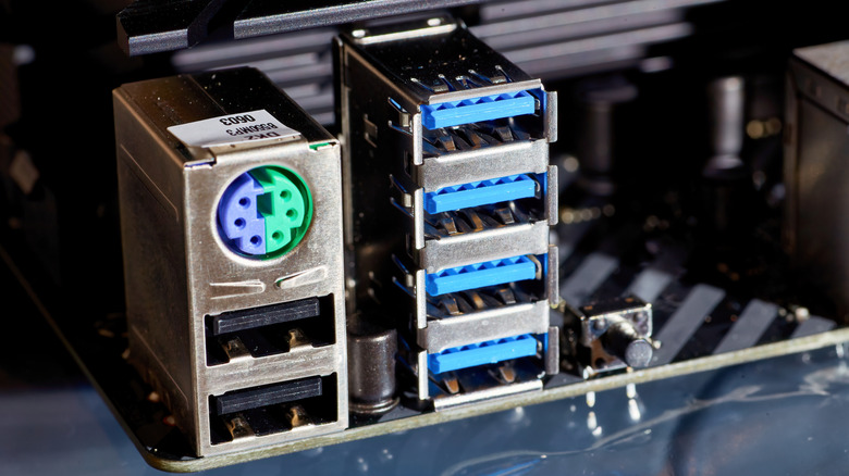 PS/2 ports visible on the back of a motherboard next to some USB ports.