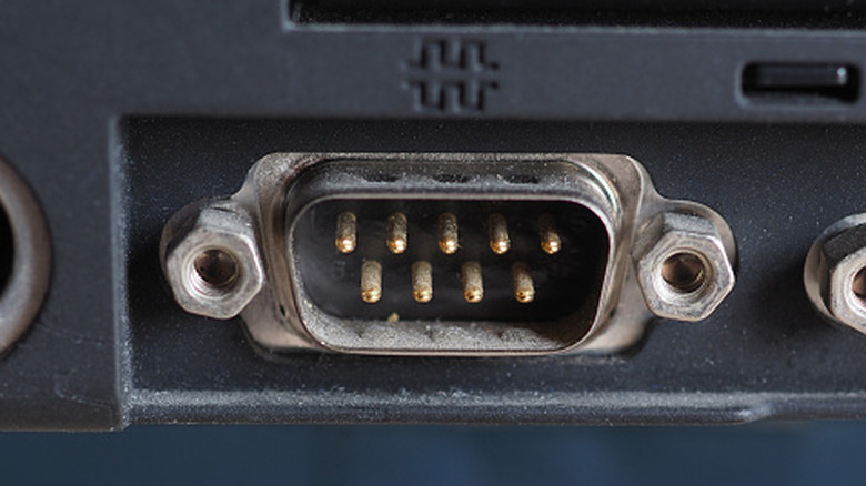 A close up shot of a serial port on an old laptop.