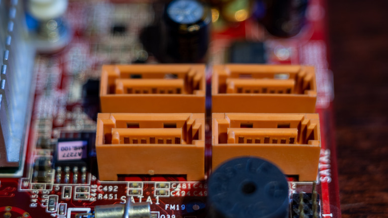 Four orange SATA ports on a motherboard.
