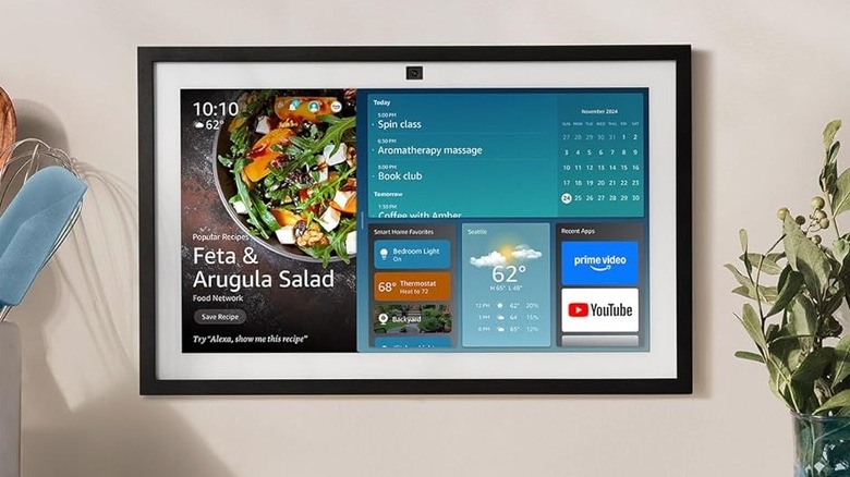 Amazon Echo Show 15 on a wall with a plant on the side