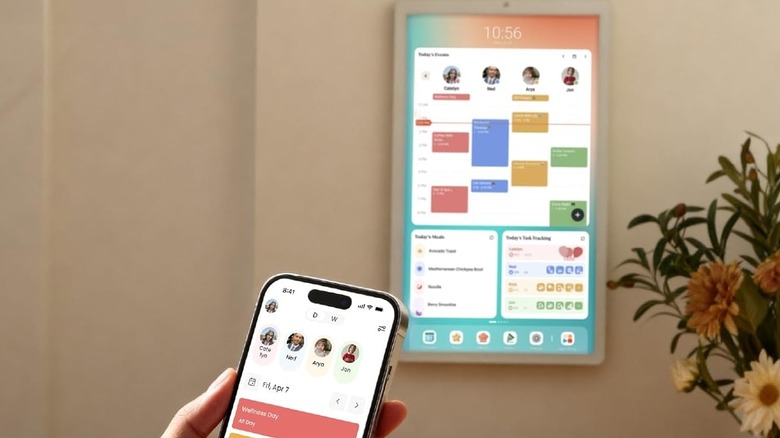 The Cozyla Calendar+ 2 in the background with a the smartphone application on display
