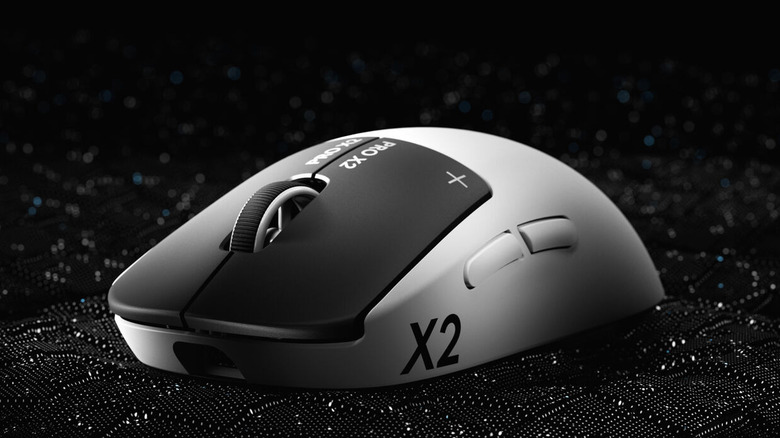 The Logitech G Pro X2 Superstrike gaming mouse on a black textured surface.