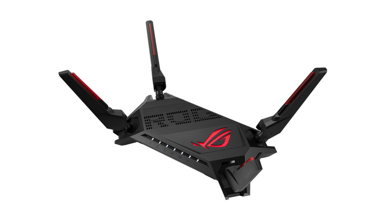 A black gaming router with red graphics and four antenna on a white background.