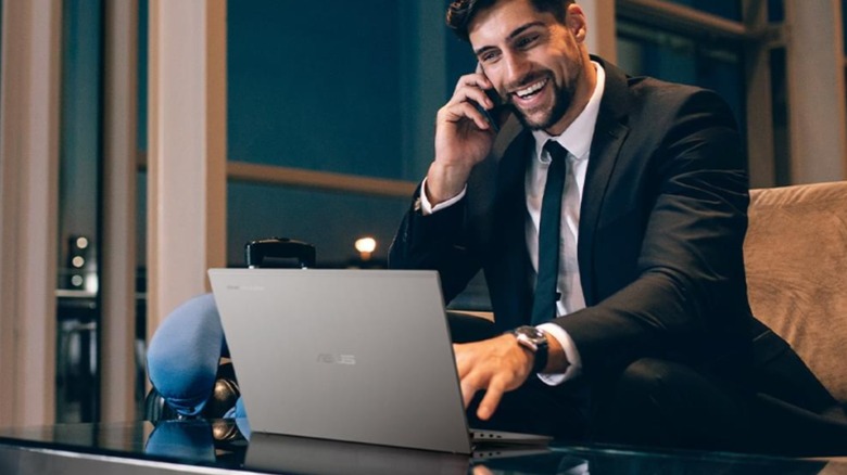 Asus Expertbook CX54 Chromebook Plus on a glass table with a man working