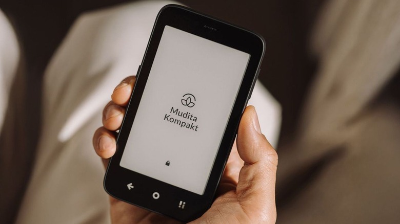 A person holding up the Mudita Kompakt phone.