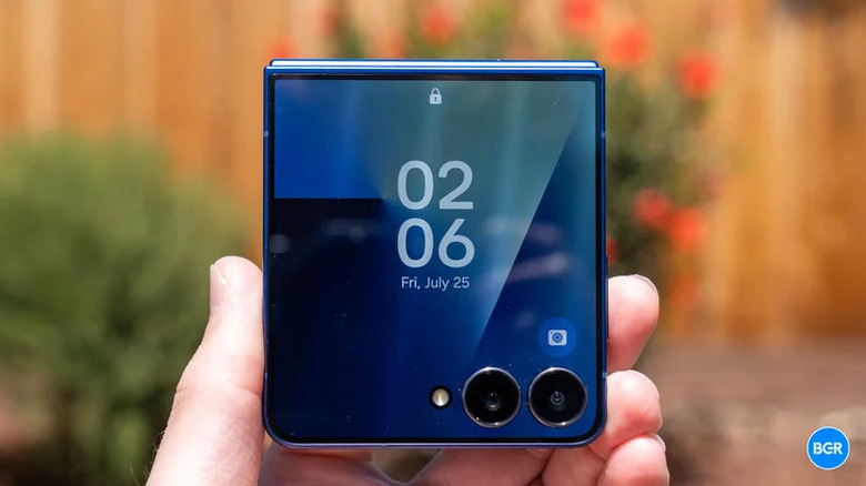 A close-up of a person holding a Galaxy Z Flip 7 in its unfolded position.