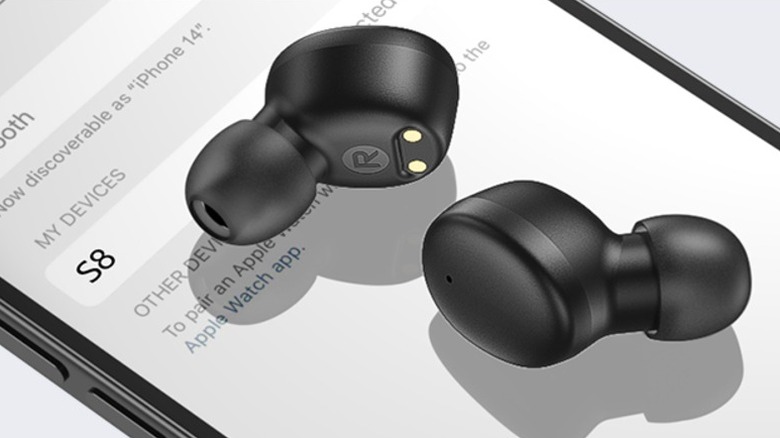 Earbuds placed on a smartphone screen.