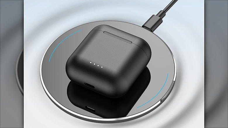 Earbud placed on a wireless charger.