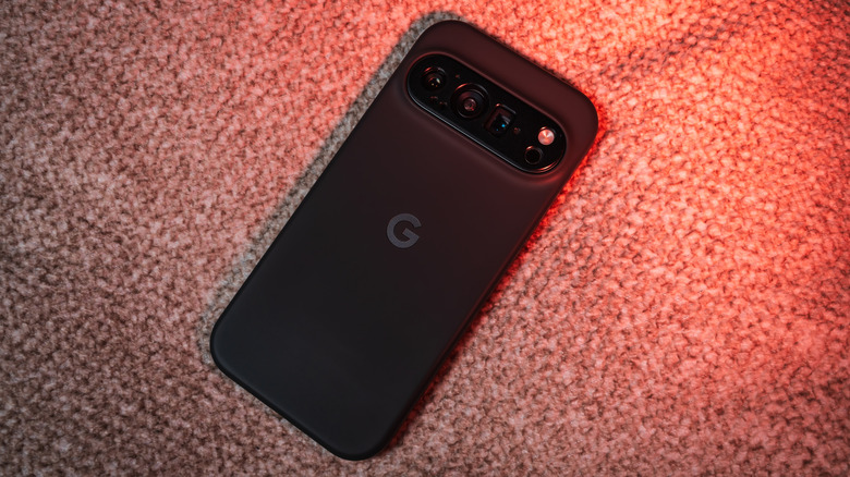 The Google Pixel 10 Pro, face down on a textured carpet