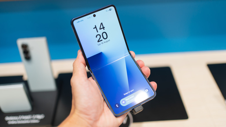 Holding the Samsung Galaxy Z Flip7 in the Samsung store