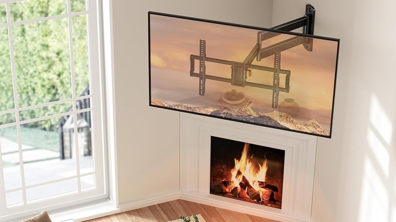 A corner TV wall mount above a fireplace.