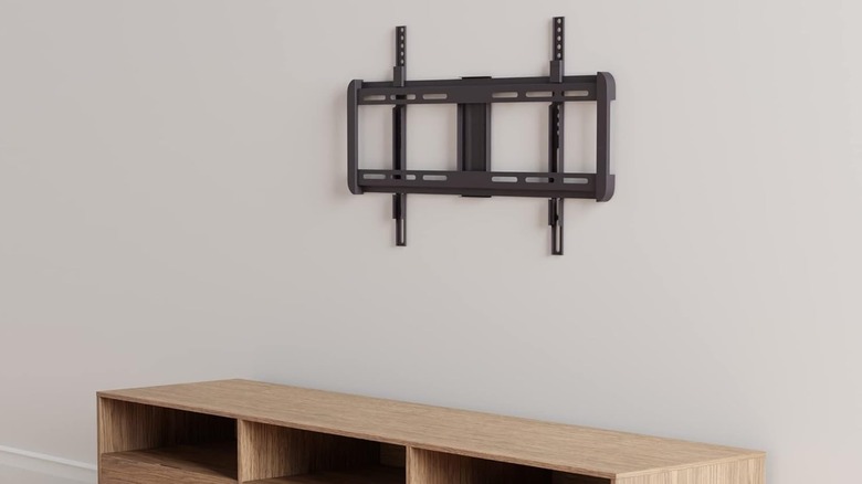 A fixed TV wall mount above a low cabinet.