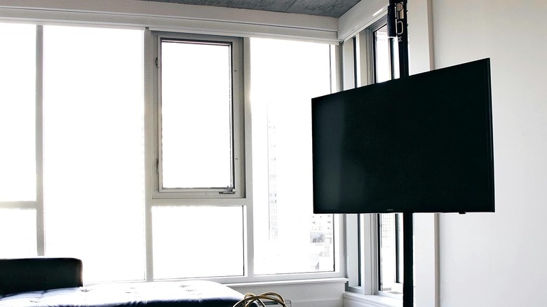 A TV installed on a MOFOPole in a modern apartment.