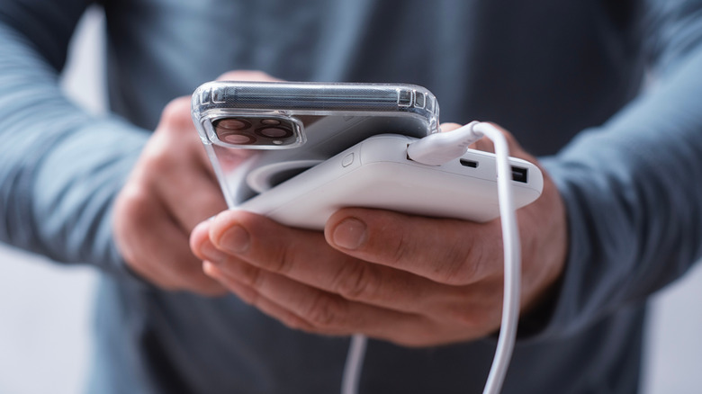 Power bank plugged into iPhone with Magsafe