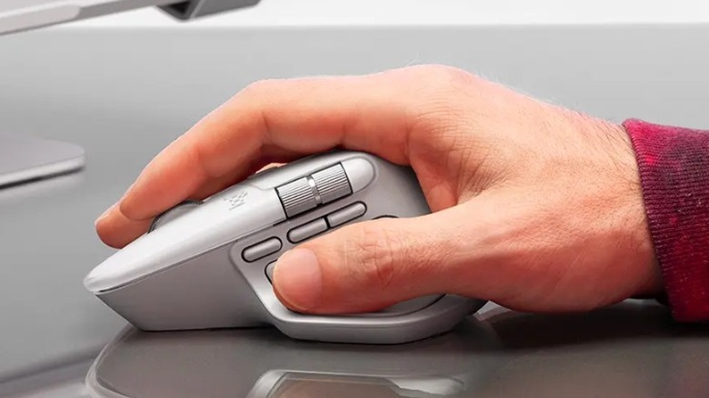 A product shot of a person using the Logitech MX Master 4 mouse