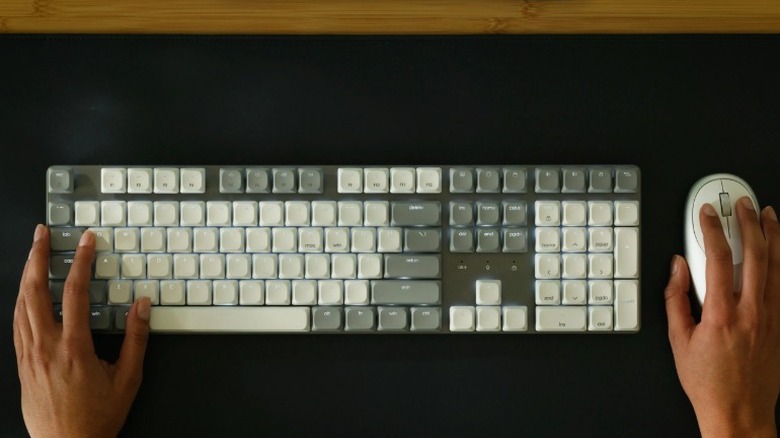An overhead shot of a person using the Satechi SM3 slim mechanical keyboard and a Satechi wireless mouse